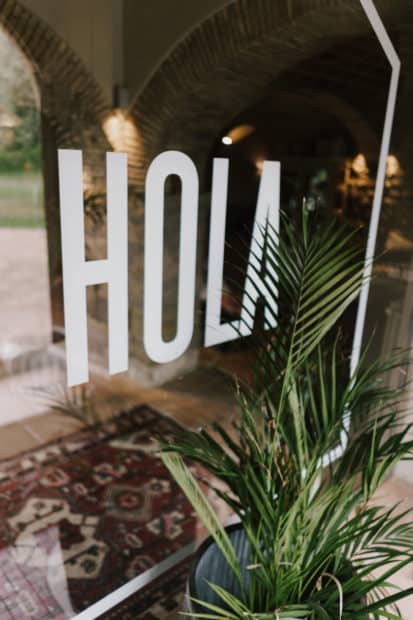 mirror with hola written on it at wedding resort