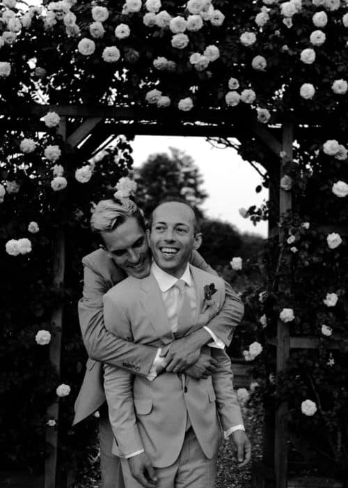 grooms embrace at the altar