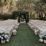 white wedding seats on manicured lawn