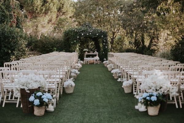 white wedding seats on manicured lawn