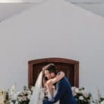 bride and groom hug at altar