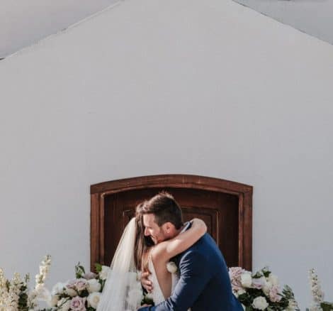 bride and groom hug at altar