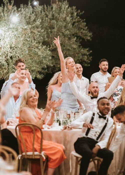 wedding guests cheer for the newly weds