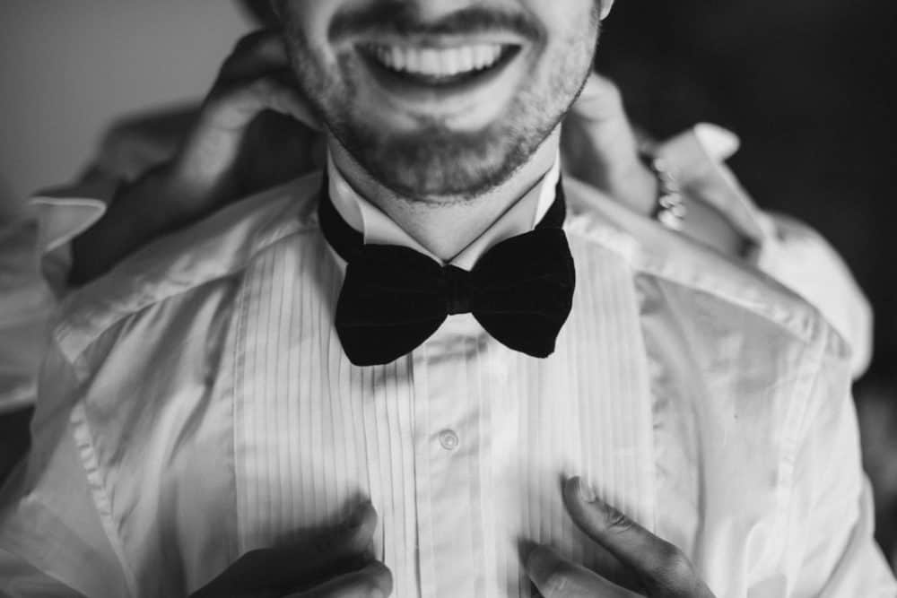 groom wearing large bowtie