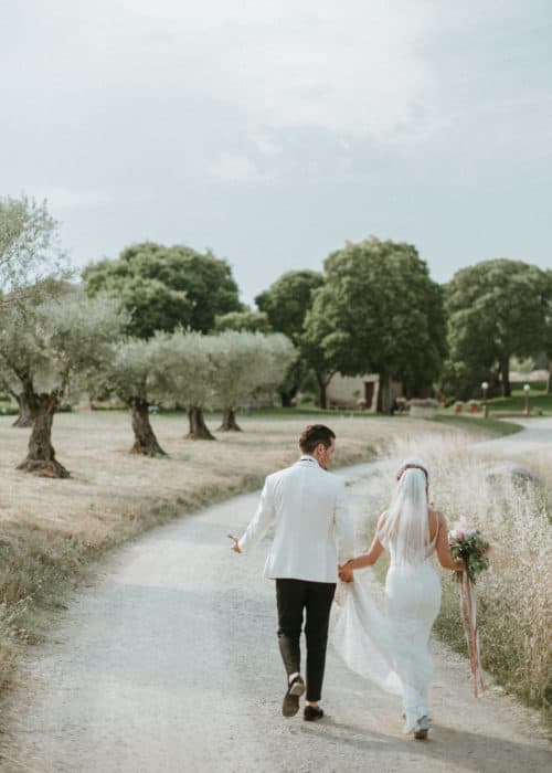 bride and groom walk down winding path
