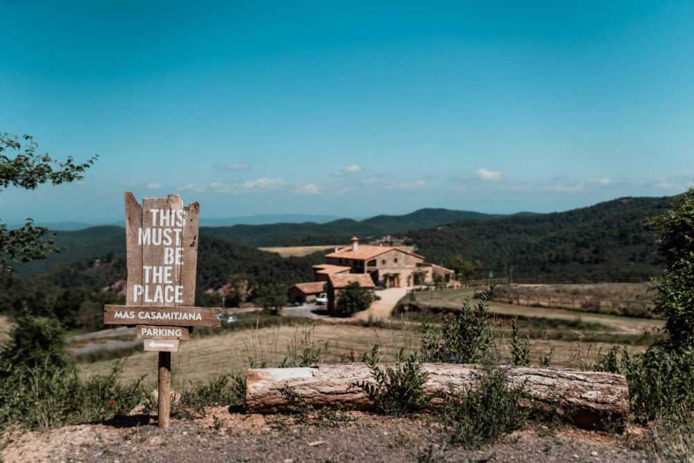 wooden sign this must be the place wedding venue in spain