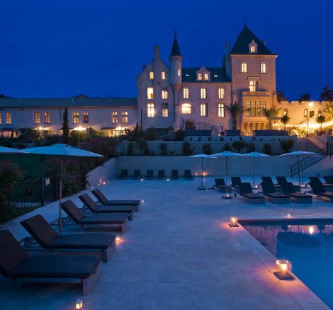chateau les carrasses lit up at night for wedding guests