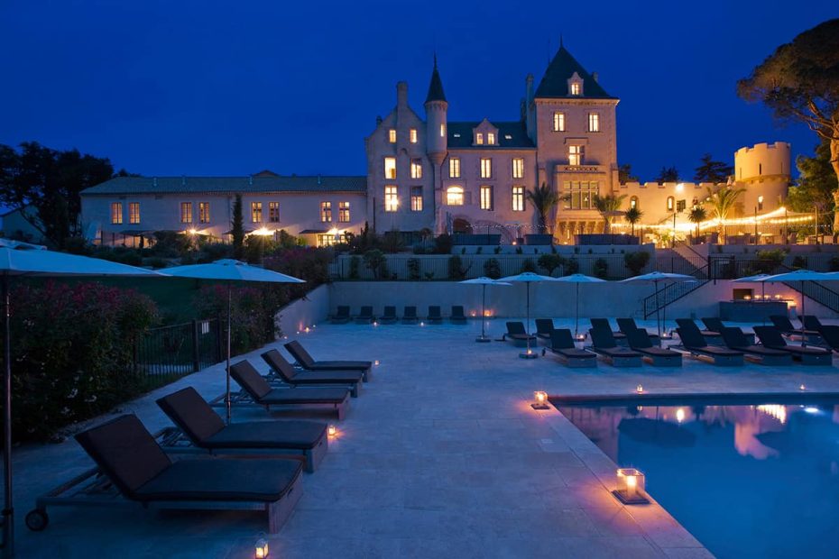 chateau les carrasses lit up at night for wedding guests