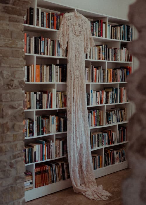 wedding dress hanging in library