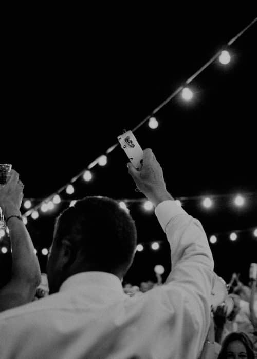 wedding guests holding up tambourines close up