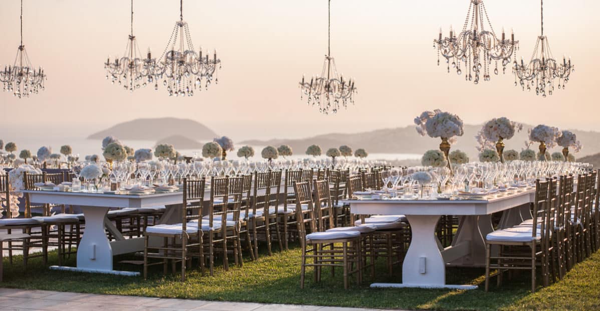 chandeliers above an outside wedding table