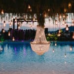lightbulbs dangling over a pool