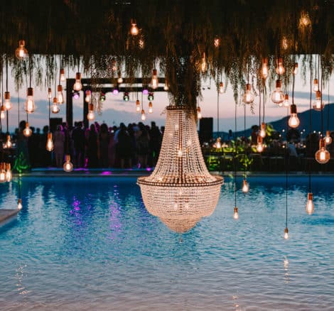 lightbulbs dangling over a pool