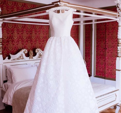 wedding gown hanging inside chateau de robernier bedroom