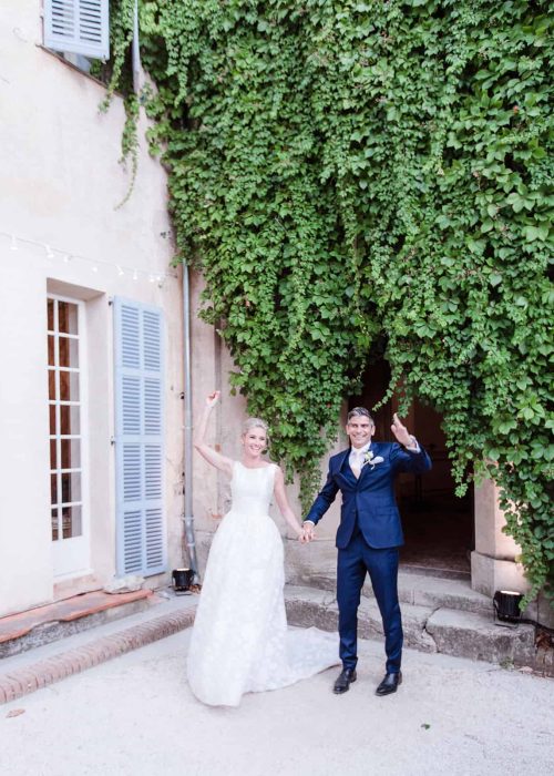 bride and groom exit chateau de robernier to get married