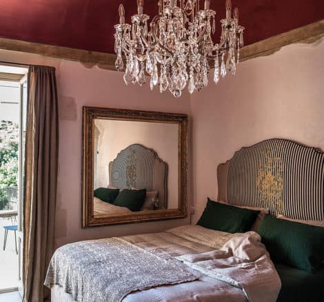 bedroom with chandelier in italy