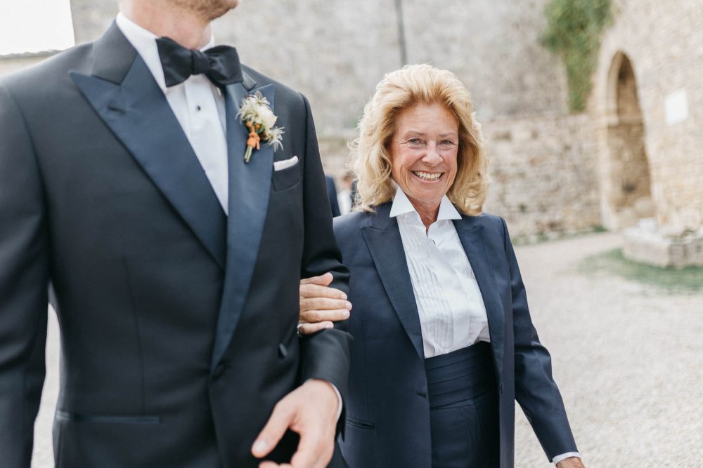 mother of the groom walking her son down the aisle