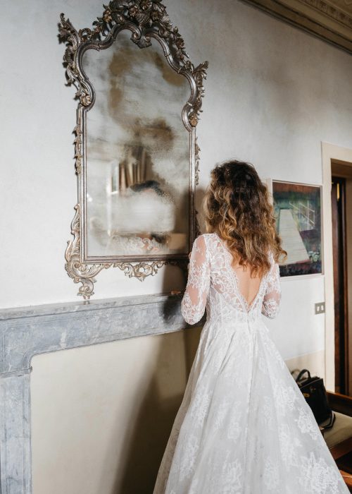 bride admiring herself in a steamed up mirror