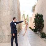 bride twirls while holding the grooms hand outside at cap rocat wedding venue in mallorca