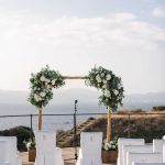 white wedding chairs facing the ocean at a wedding ceremony in mallorca at cap rocat
