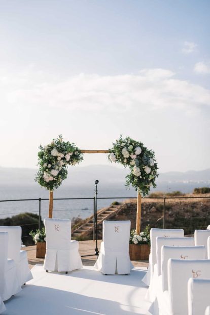 white wedding chairs facing the ocean at a wedding ceremony in mallorca at cap rocat