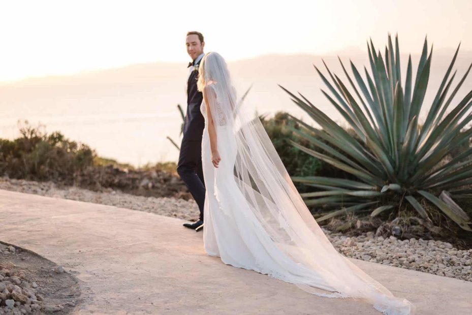 Bride and Groom, Alex and Kat walk into the sunset at their cap rocat wedding venue in Mallorca