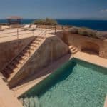 stone stairs leading down to large pool area for guests at spanish wedding venue cap rocat