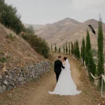 Bride and Groom walking away through the mountainous valley at Honeyli Hill Wedding Venue in Larnaca Cypruslandscape