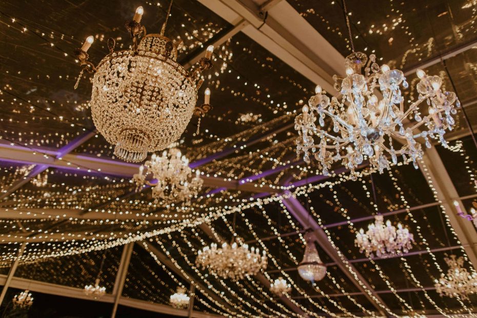 chandeliers dangling from glass ceiling at wedding venue