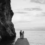 black and white photo of married couple on pier