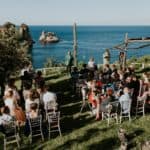 guests clapping at seaside wedding