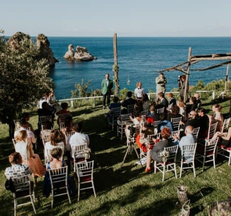 guests clapping at seaside wedding