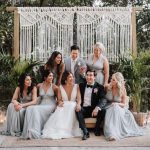 photo of bride and groom gathered with friends after wedding