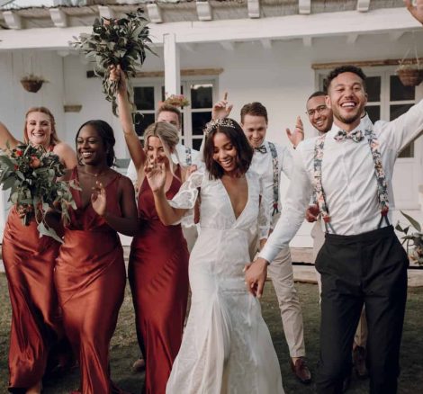 bridesmaids wearing terracotta satin long dresses cheer as the bride and groom dance spanish wedding venue casa la siesta