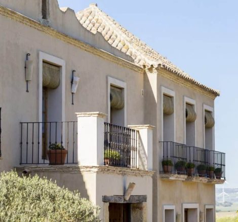 exterior view of balconies with potted plants at spanish wedding venue casa la siesta