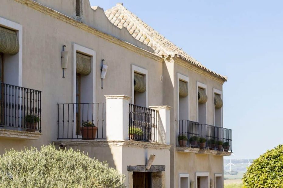 exterior view of balconies with potted plants at spanish wedding venue casa la siesta