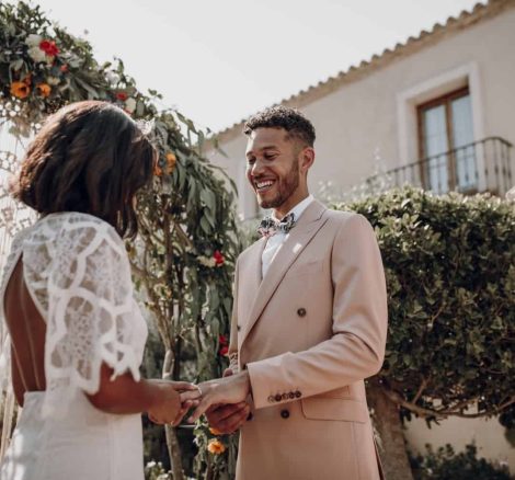 the groom placing the ring on the brides finger on their wedding day at cash la siesta wedding venue in spain