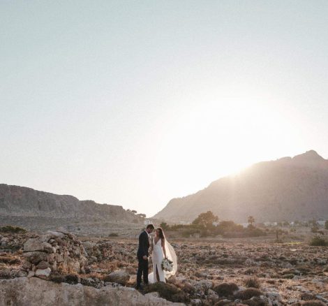 bride and groom pose on rocky landscape