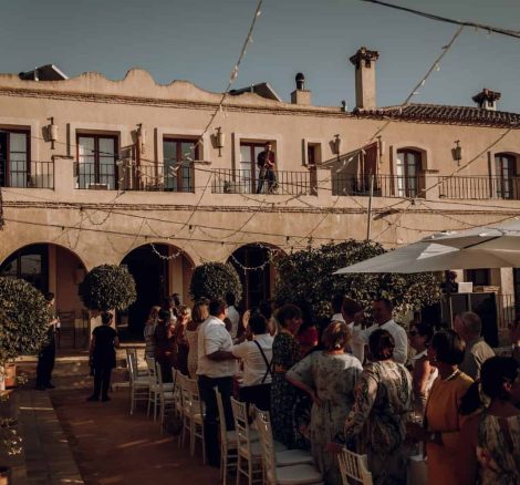 wedding guests stand to see musicians spanish wedding venue casa la siesta