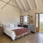 spanish wedding villa bedroom with picturesque view over the nearby vineyards at spanish wedding venue casa la siesta in spain