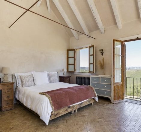 spanish wedding villa bedroom with picturesque view over the nearby vineyards at spanish wedding venue casa la siesta in spain