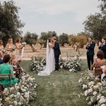 bride and groom kiss in a basic outdoor wedding setting