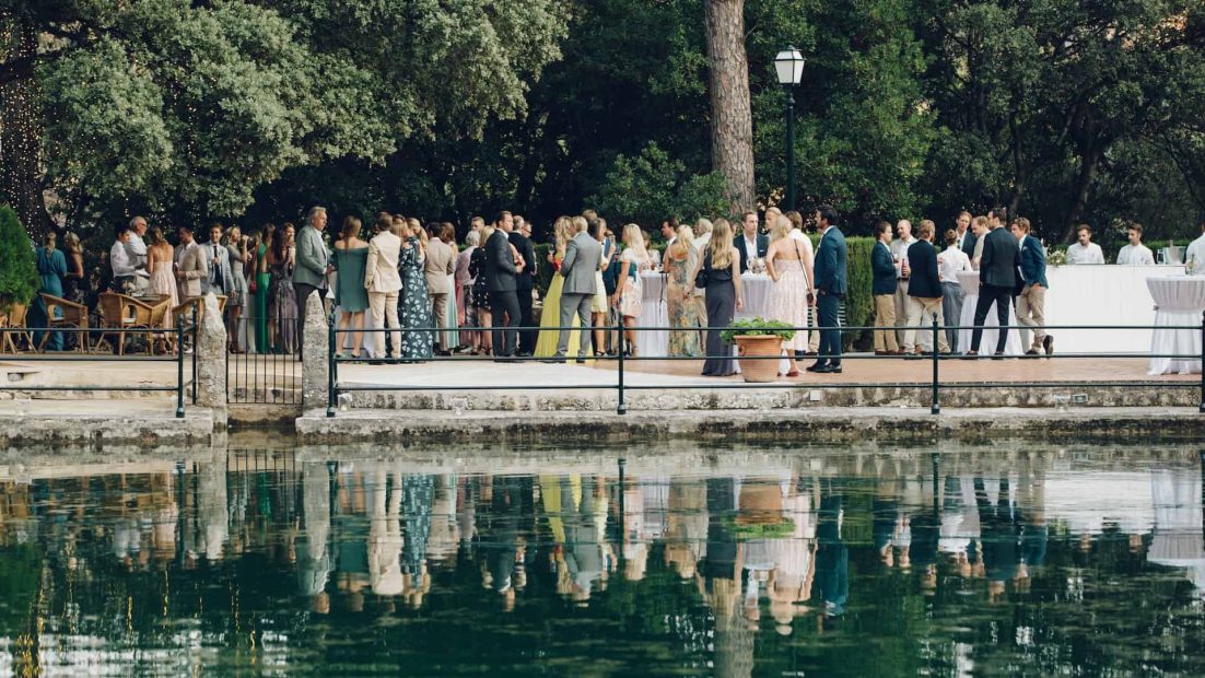 wedding guests gathered near pool at finca comassema