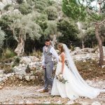 bride and groom walk down stony path