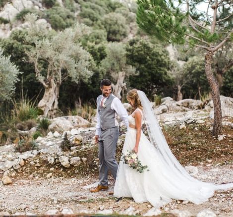 bride and groom walk down stony path