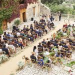 wedding in mallorca with guests seated on bamboo chairs