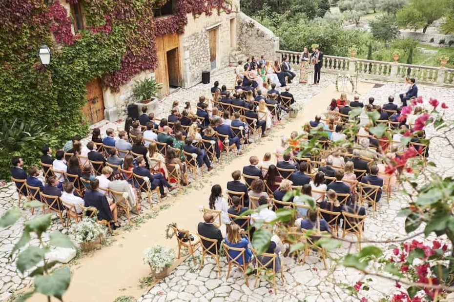wedding in mallorca with guests seated on bamboo chairs
