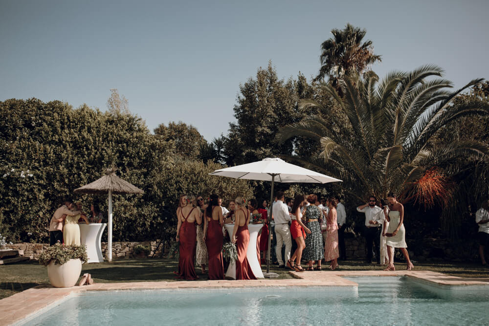 wedding guests unwind by the pool