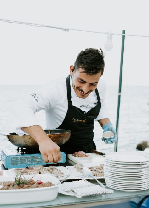 chef smiling while preparing wedding food