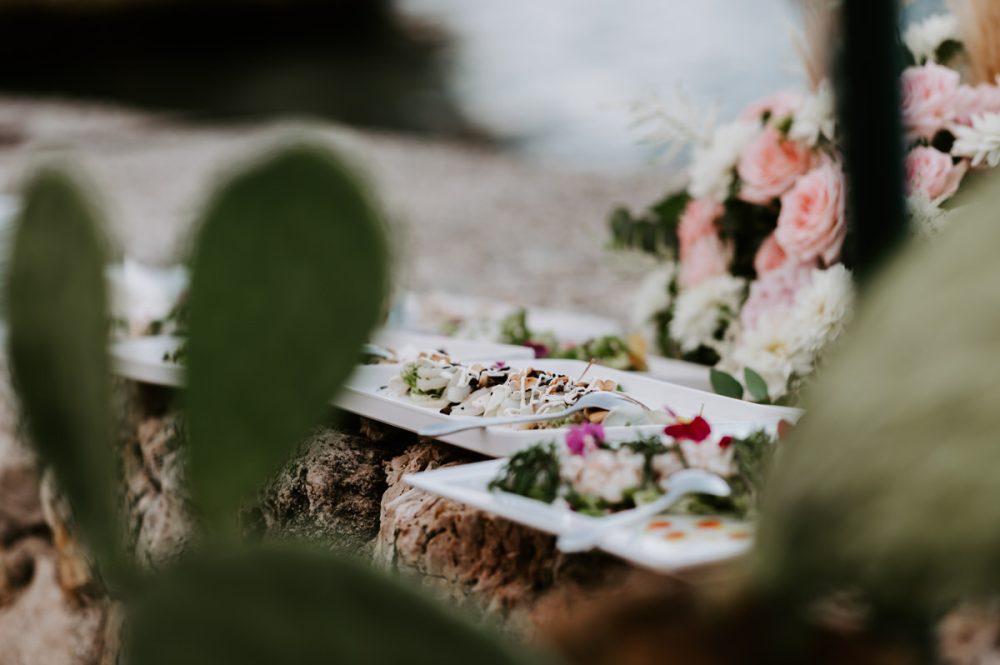 wedding food next to floral arrangement